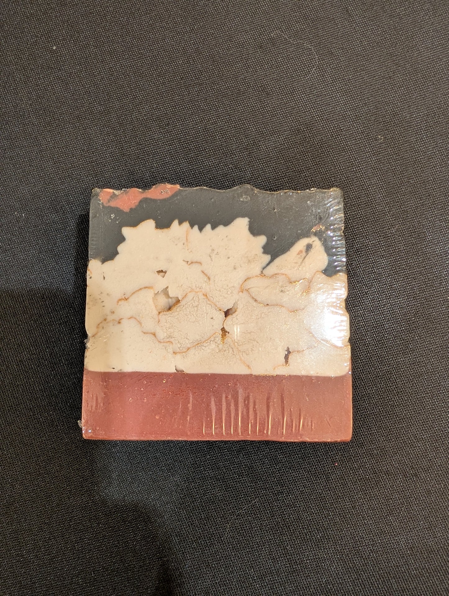 Chapter I: I Saw You First handmade soap showing layered burgundy, white, and black design — side view
